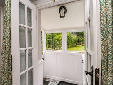An entryway with a door and windows leading to a garden at 3 Tre Felin Llandygai near Bangor
