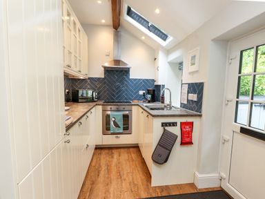 A kitchen with cabinets and countertop at 3 Tre Felin Llandygai near Bangor