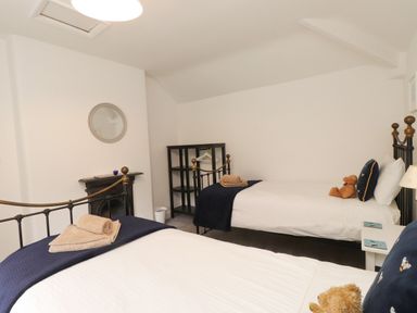 A bedroom with two beds and a teddy bear at 3 Tre Felin Llandygai near Bangor