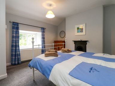 A bedroom with a double bed and accessories at 3 Tre Felin Llandygai near Bangor