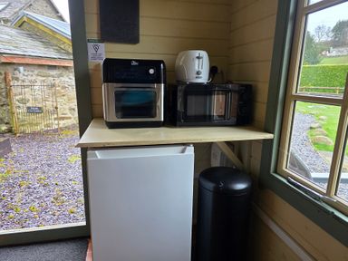 A kitchen area with appliances at Cwt Tyddyn Shepherd's Hut Cefn Brith near Cerrigydrudion