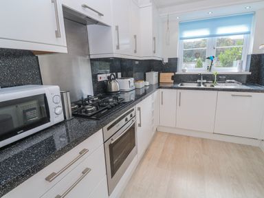 A kitchen with appliances and fixtures at 21 Compass Point in Carbis Bay