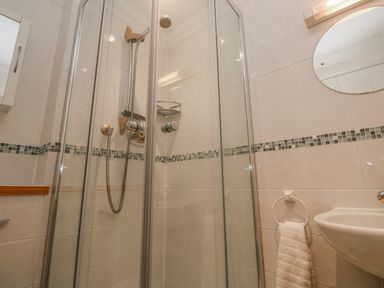 A shower area with a mirror and sink at 21 Compass Point Carbis Bay