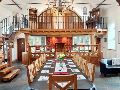 A dining room with a large table and chairs at Kaber Chapel near Kirby Stephen