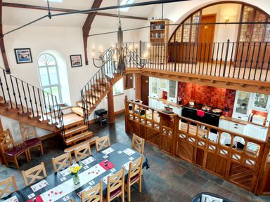 A dining room with a staircase and kitchen area at Kaber Chapel Kaber near Kirby Stephen