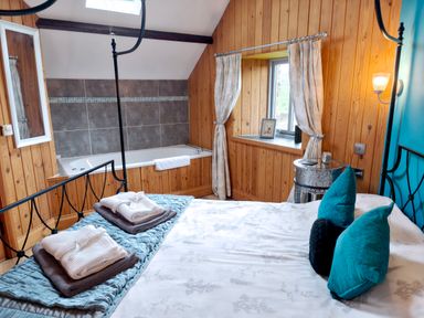 A bedroom with a bathtub and window at Kaber Chapel in Kaber near Kirby Stephen