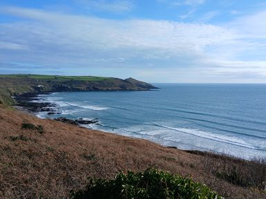 A coastal view with waves and hills at The Cabin in 