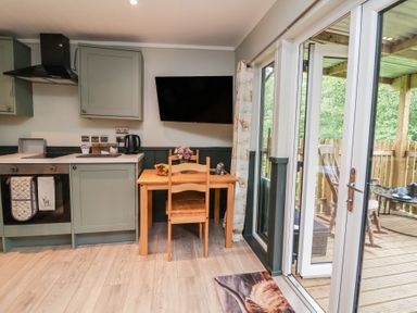 A kitchen with a table and chairs at Robins Nest Lodge in South Molton