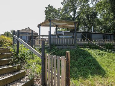 An outdoor area with steps leading to a deck at Hedgehogs Lodge South Molton