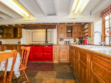A kitchen with cabinets and a stove at The Farmhouse in Keswick