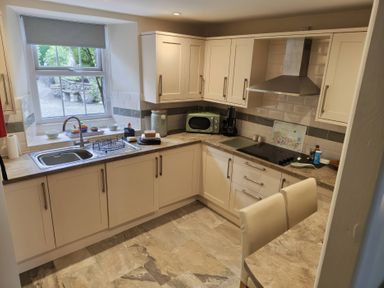 A kitchen with a sink and stove at Bobbin Nook in Staveley