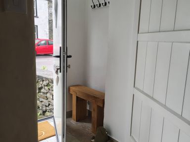 An entrance hall with a bench and coat hooks at Bobbin Nook in Staveley
