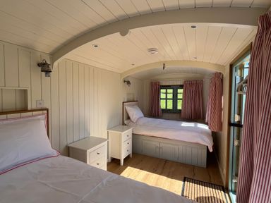 A bedroom with two beds and a window at The Orchard in Ringstead