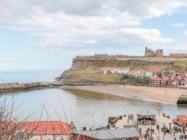 A coastal view with houses and cliffs at The Hideaway in Whitby