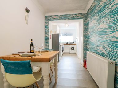A kitchen with a table and chairs at The Hideaway in Whitby