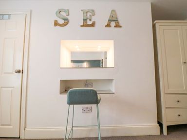 A bedroom with a desk and stool at The Hideaway in Whitby