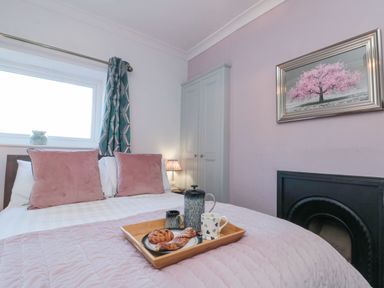A bedroom with a bed and a tray of snacks at Cuckoo's Nest in Whitby