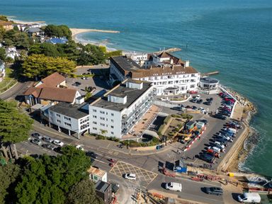 A coastline view with The Haven Hotel and parked cars at Flat 17 Golden Gates Sandbanks