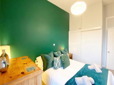 A bedroom with a bed and a bedside table at 2A Redcliffe in Torquay