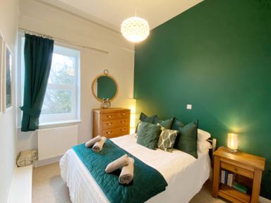 A bedroom with a bed and furniture at 2A Redcliffe in Torquay