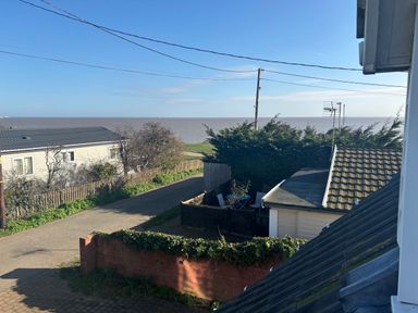 A view of the sea and houses from an outdoor area at Seaview in Pakefield