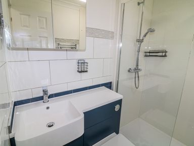 A bathroom with a sink and shower at The Nest Lodge 55 Grantham