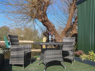 An outdoor seating area with a table and chairs at Salt Haven Shepards Hut Pevensey