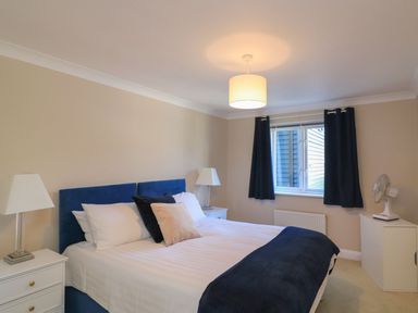 A bedroom with a bed and bedside tables at 6 Dartmouth House in Dartmouth