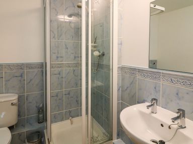 A bathroom with a shower and sink at 6 Dartmouth House in Dartmouth