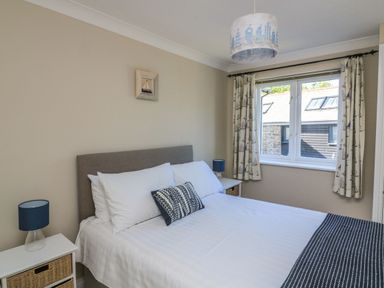 A bedroom with a bed and bedside table at 6 Dartmouth House in Dartmouth
