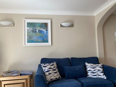 A living room with a blue sofa and a table beside it at 6 Dartmouth House, Dartmouth