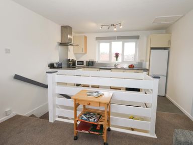 A kitchen with appliances and a table at Amber House in Dorchester