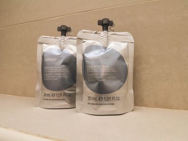 Two shampoo packets on a counter at Time Out in Whitby