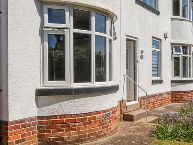An outdoor area with windows and a front door at The Arches in Torquay