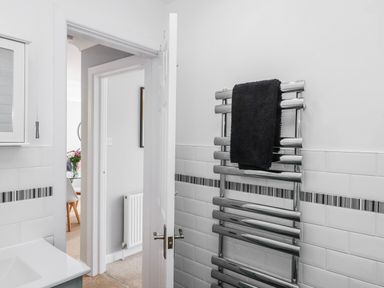 A bathroom with a towel rail and sink at The Arches in Torquay