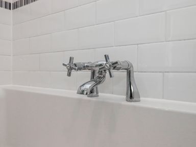 A faucet with handles above a bathtub at The Arches in Torquay