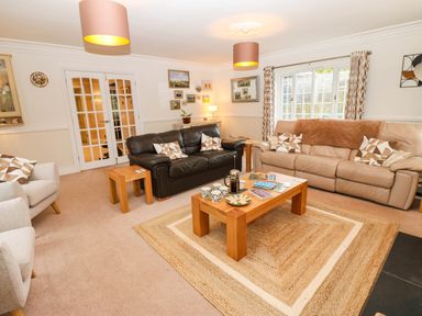 A living room with sofas and a coffee table at Stone Lodge near Haltwhistle