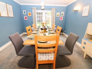 A dining room with a table and chairs at Stone Lodge near Haltwhistle