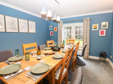 A dining room with a table set for meals at Stone Lodge near Haltwhistle