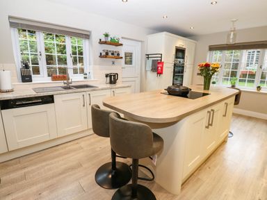 A kitchen with a sink and island at Stone Lodge near Haltwhistle