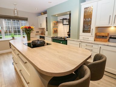 A kitchen with a central island and cabinets at Stone Lodge near Haltwhistle