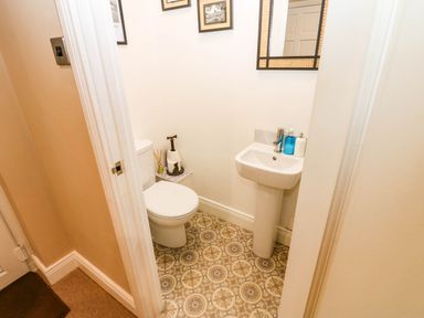 A bathroom with a toilet and sink at Stone Lodge near Haltwhistle