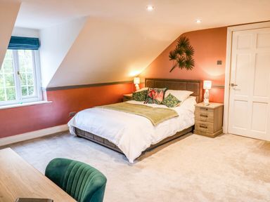 A bedroom with a bed and desk at Stone Lodge near Haltwhistle