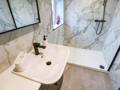 A bathroom with a sink and shower at Stone Lodge near Haltwhistle