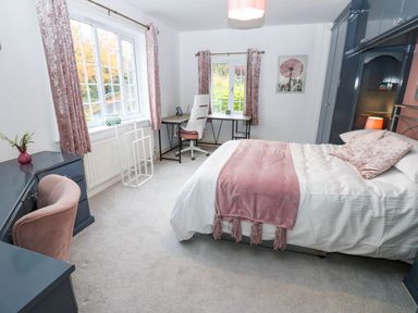 A bedroom with a bed and desk at Stone Lodge near Haltwhistle
