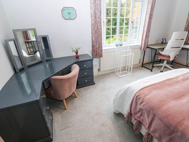A bedroom with a bed and a desk at Stone Lodge near Haltwhistle