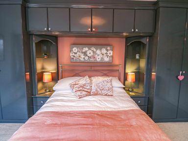 A bedroom with a bed and lamps at Stone Lodge near Haltwhistle