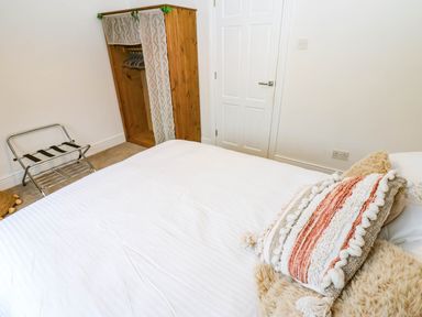 A bedroom with a bed and a wardrobe at Stone Lodge near Haltwhistle