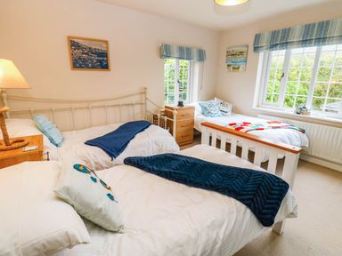 A bedroom with two beds and a nightstand at Stone Lodge near Haltwhistle