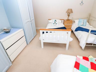 A bedroom with two single beds and a nightstand at Stone Lodge near Haltwhistle